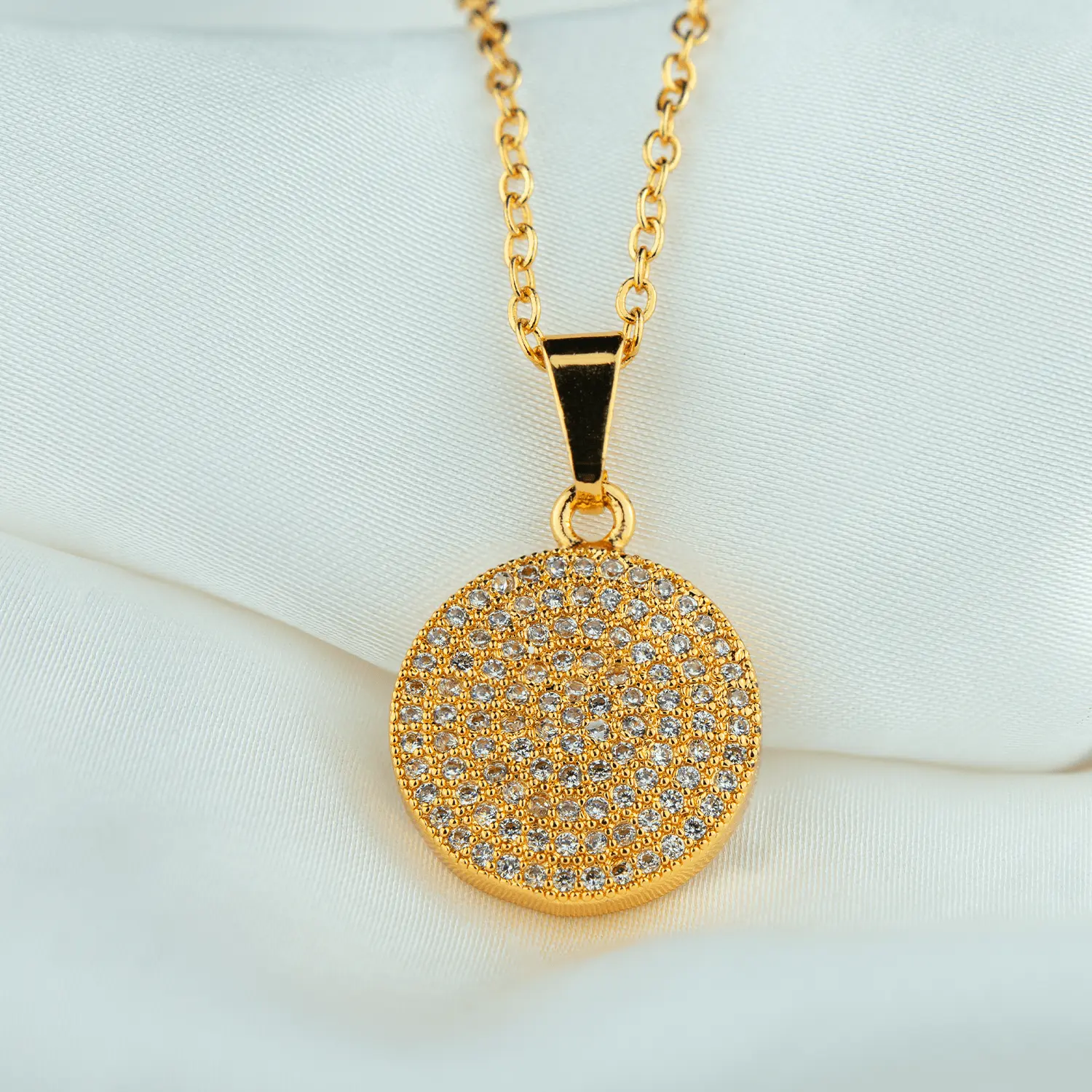 Golden glam jewellery with circular zirconia pendant
